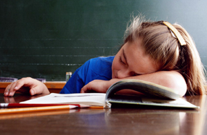 Girl sleeping at her desk.