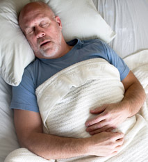 Man sleeping in bed.