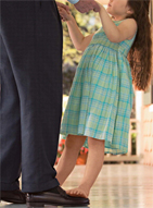Little girl and man dancing. Girl is standing on mans feet